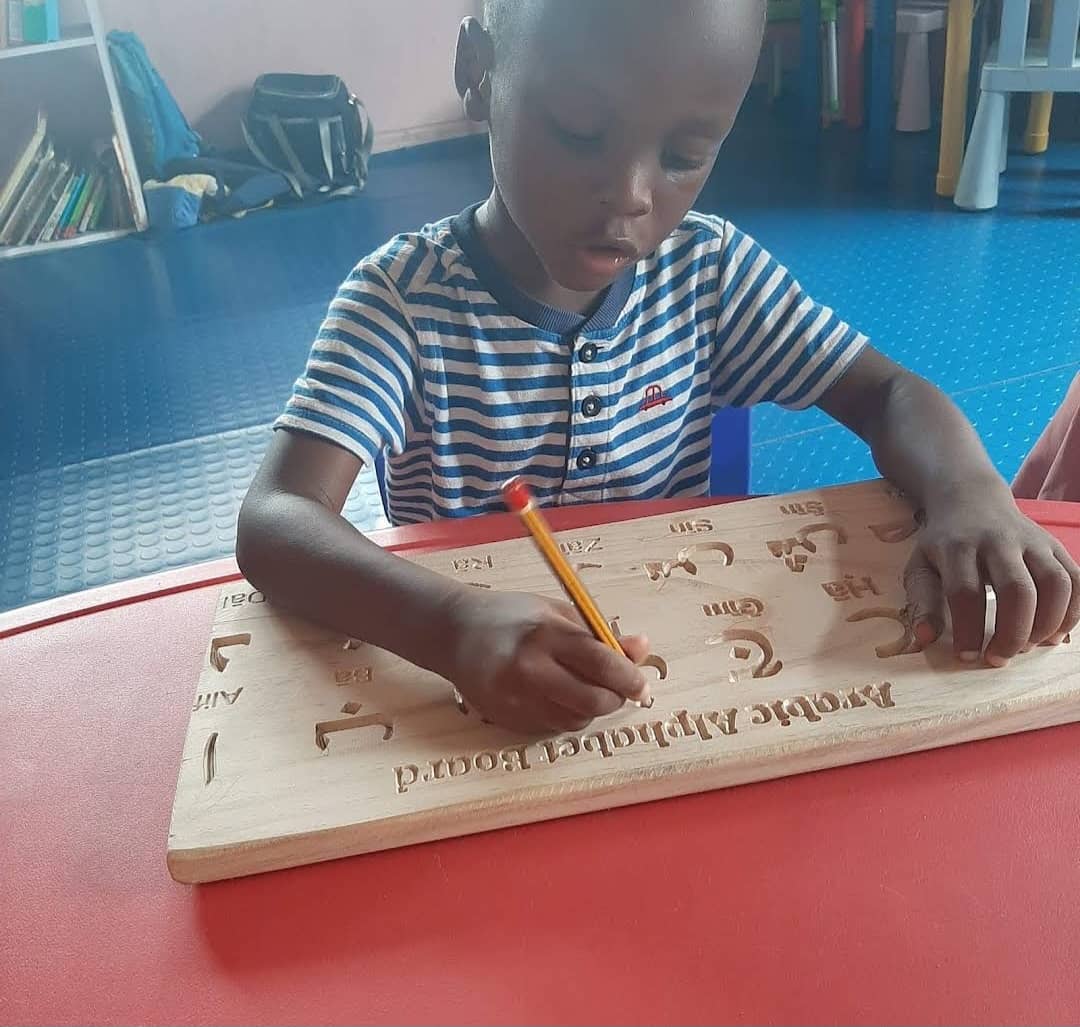 A pupil reading Arabic and Quran learning materials